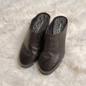 Walking Cradles black leather embossed mules